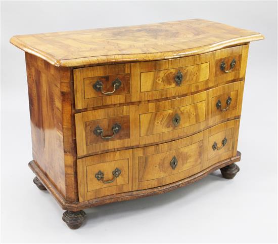 An 18th century German marquetry inlaid walnut serpentine commode, W.3ft 8.5in.